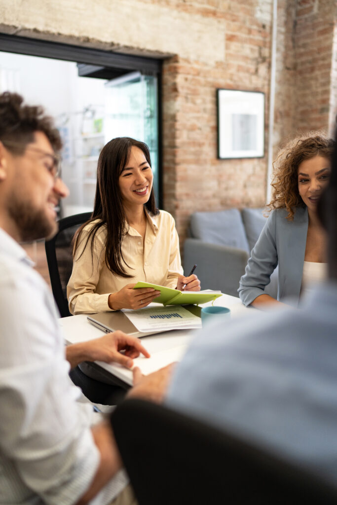 Diverse business professionals collaborating during a happy office meeting