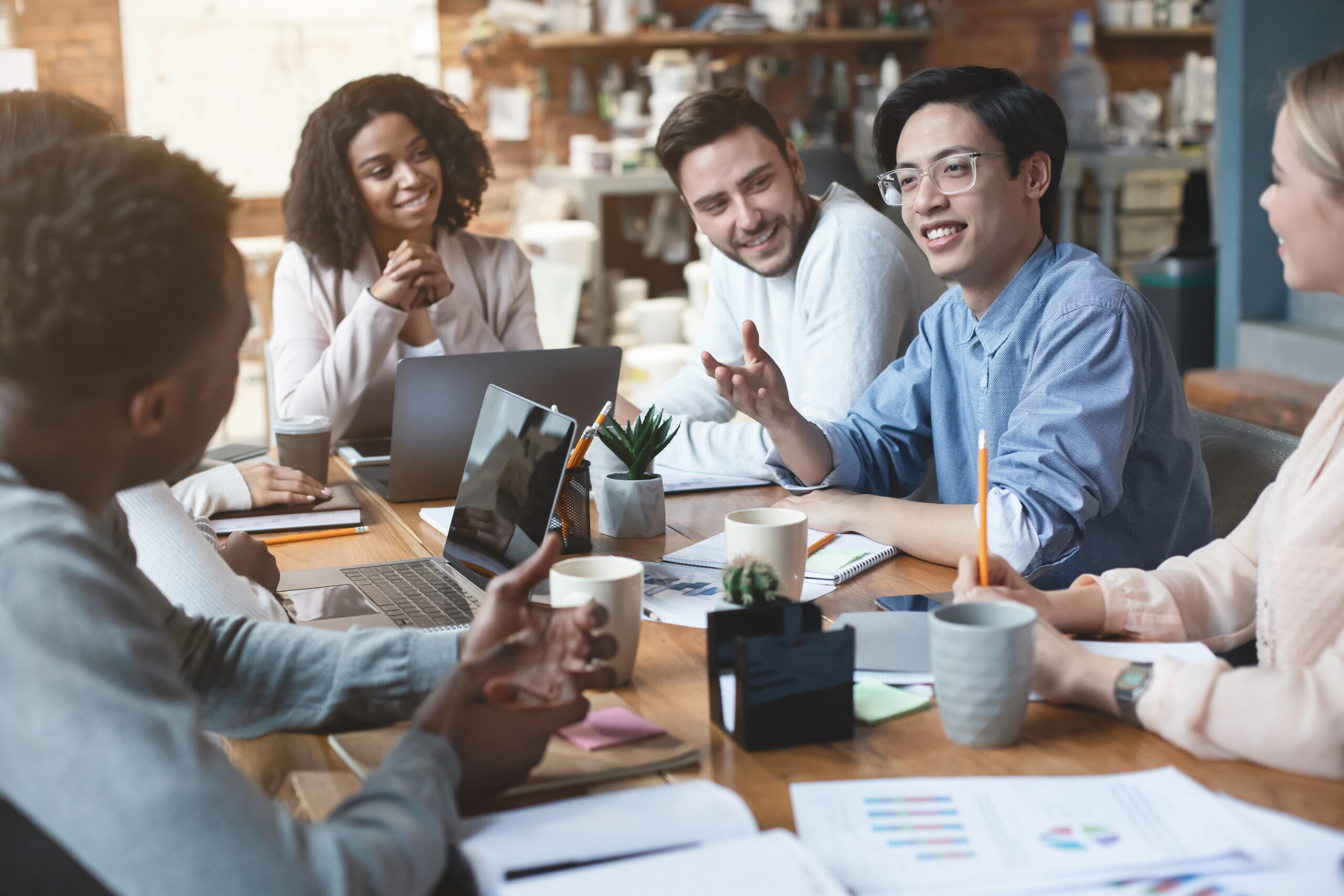 Close up of young people having business meeting in office